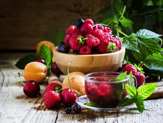 Summer fruit tea with mint in a glass cup, fresh fruit and berri
