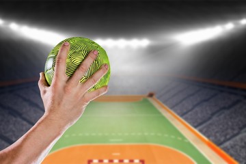 Composite image of sportsman holding a ball