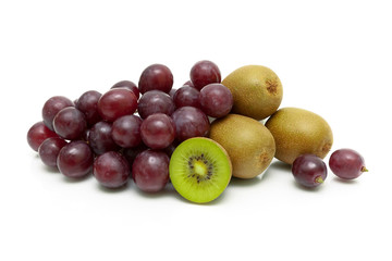 ripe kiwi and dark grapes on a white background