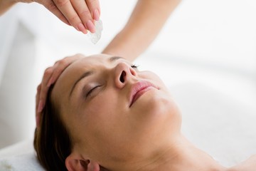Fototapeta na wymiar Cropped image of masseur giving massage to woman
