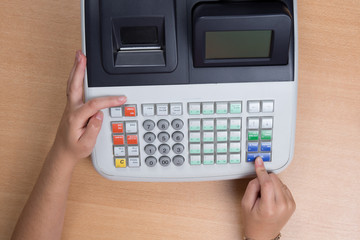 Hand Swiping Credit Card In a Store with cash register