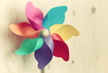 Colored windmill on  Wood background