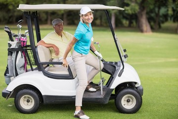 Portrait of smiling golfer couple 