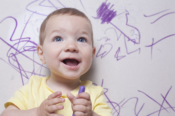 Baby boy scrawling writing