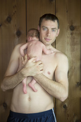 New born baby over his fathers shoulders