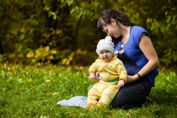 Mama and child on the green lawn