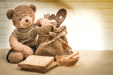 cup honey on sackcloth with Teddy - 114068555