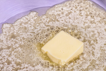 Piece of butter in the hot pan top view