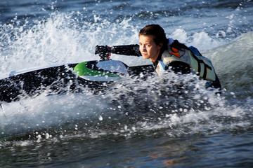 Naklejka premium .beautiful girl riding her jet skis.