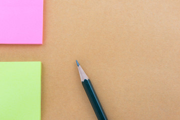 Color  Paper notes with sticky note on brown Background