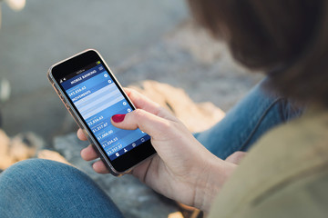 Woman touch the screen of her smartphone with mobile banking