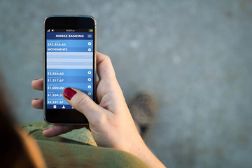 Woman walking smartphone mobile banking interface