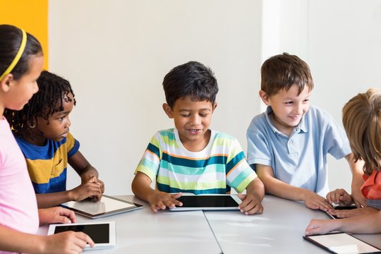 Children using digital tablets in classroom
