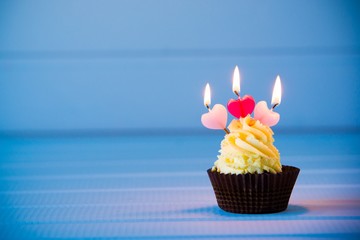 cupcake with a heart shaped candles for 3 - third birthday