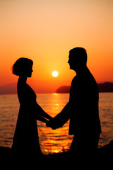 Couple in Love. Silhouette of Man and Woman during Sunset