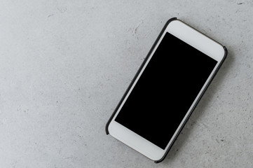 Blank smartphone on grey tile background