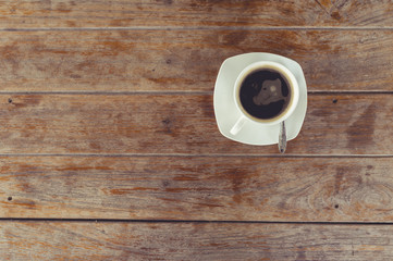 A cup of hot coffee on table.