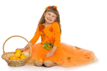Happy little blond girl, in a bright orange dress, with a basket in which lay a ripe pumpkin - Isolated on white background