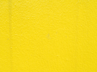 pastel yellow color painted on rough concrete wall texture background