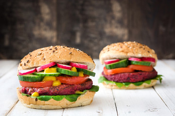 Veggie beet burger on white wooden background

