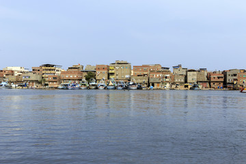 Residential houses and boats on river nile,Damietta, Egypt.. © Mohamed