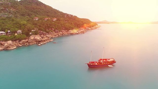 Aerial view of amaizing island in Thailand and red sail ship