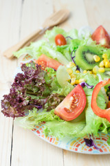 Fresh vegetable salad on wooden table