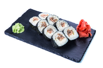Sushi Set and sushi rolls on black stone slate. Restaurant food concept.