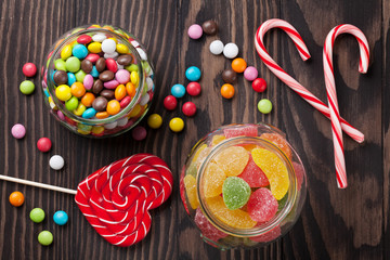 Fototapeta na wymiar Colorful candies on wooden table
