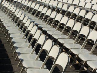 Many white chairs lined in rows pattern