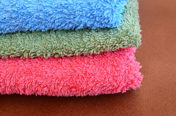 Colorful stacked bathroom towels close up.Selective focus.