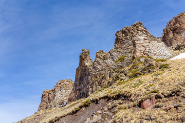unusual geological rock or cliff in the mountains with basalt collumns