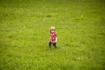 small boy on green grass