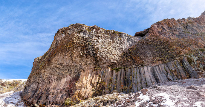 unusual geological rock or cliff in the mountains with basalt collumns