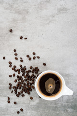 Coffee and coffee beans on concrete background