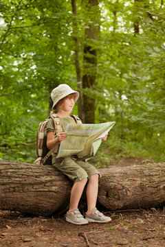 summer camps,scout child read map in forest