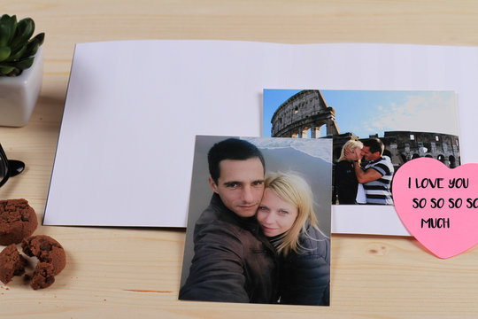 Love, relationship, Honeymoon, Italian holidays concept. Photos of couple in love and blank greeting card / message on wooden table. St. valentine's day background, copy space