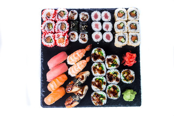 Sushi Set  and sushi rolls on black stone slate. Restaurant food concept.