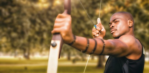 Composite image of front view of sportsman practising archery 