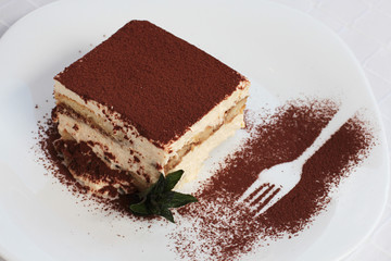 Tiramisu cake, slice on a plate 