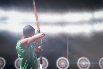 Composite image of rear view of sportsman doing archery - obrazy, fototapety, plakaty