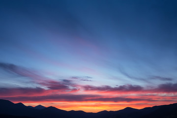 Colorful beautiful sunset over the mountain hills