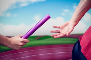 Athlete passing a baton to the partner