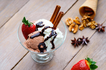 Ice cream sundae, waffle cone, walnuts and strawberry 