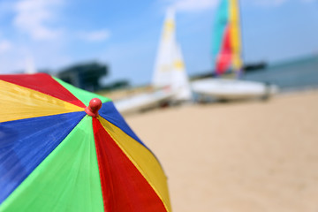 Top of a Colorful Beach Umbrella against the Sky and boat and se