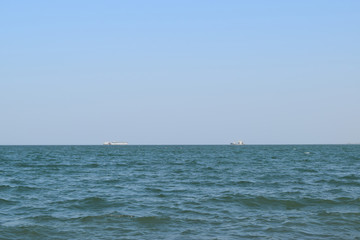 Seascape and two ships on the horizon