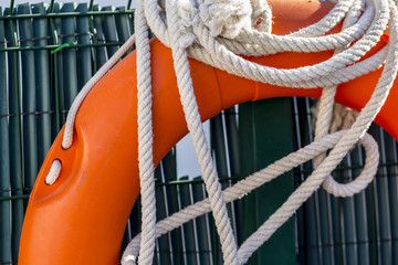 White rope and float in the lifeguard post of a swimming pool