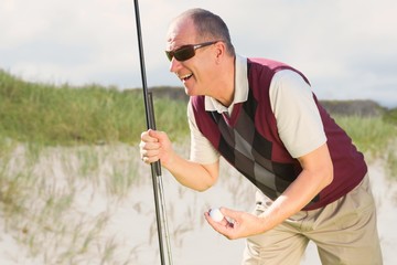 Composite image of man playing golf