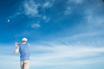 Rear view of man playing golf 