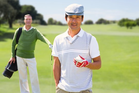 Composite image of golfing friends smiling at camera 